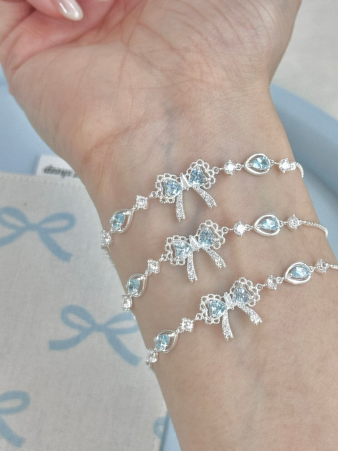LolaWhite "Lingering Rainlight" Blue Zircon Lace Bow Bracelet – Silver Plated, Dazzling & Sweet